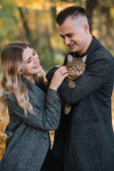 love, relationship, family and people concept - smiling couple having fun in autumn park