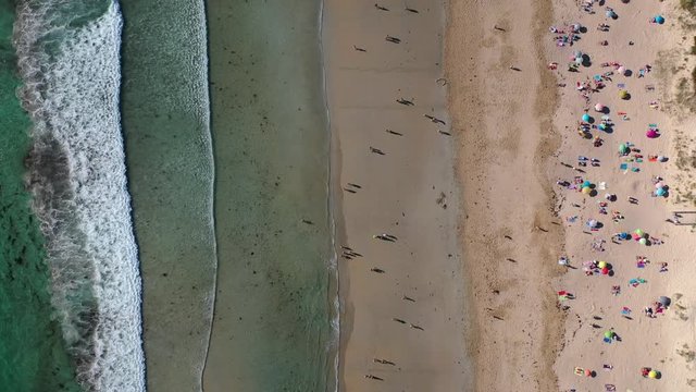 ocean waves sandy beach with people bathing in the water view from drone Lanzada beach Galicia Spain 4k video