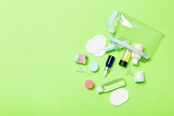 Top view of means for face care: bottles and jars of tonic, micellar cleansing water, cream, cotton...