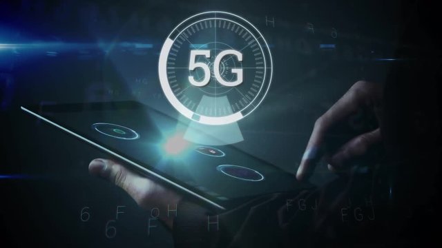 5G displayed in a circle with person using tablet in the background