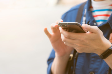 a man hold smartphone and wear a digital watch