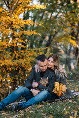 Fototapeta premium love, relationship, family and people concept - smiling couple having fun in autumn park