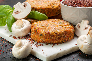 Tasty vegetarian and vegan burgers made from healthy quinoa, basil, tomatoes and champignon mushrooms