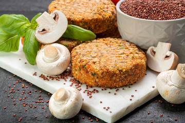 Tasty vegetarian and vegan burgers made from healthy quinoa, basil, tomatoes and champignon mushrooms