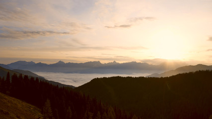 Naklejka na ściany i meble beautiful morning and sunrise in the mountains with view to the alps and fog in the valley