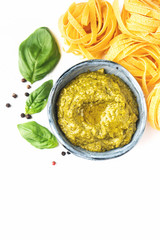Popular italian pesto sauce. Pasta cooking concept, ingredients and spices. Vegetarian food. Top view, close-up, isolated.
