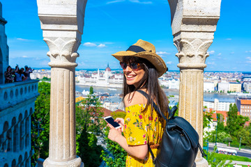 A young woman taking pictures of Budapest