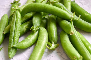 many of Green Pea Pods on factured surface