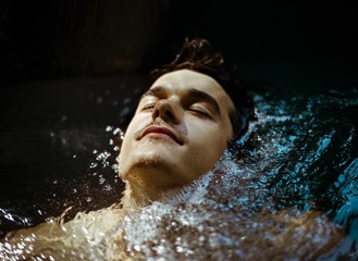 Portrait of young man in hot tub 