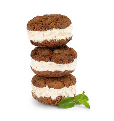 Sweet delicious ice cream cookie sandwiches and mint on white background