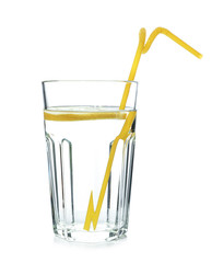 Glass of water with lemon and straw on white background. Refreshing drink