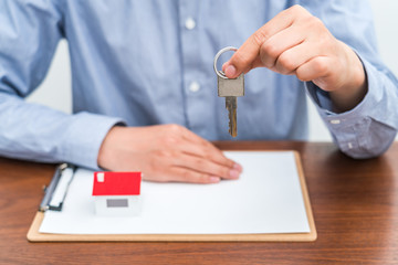 Real estate agent holding keys in hand