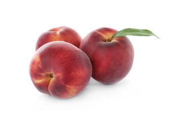 Fototapeta na wymiar Delicious ripe peaches with leaf isolated on white