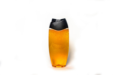 plastic bottle with black lid and orange shower gel isolate