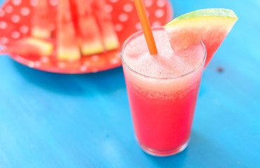 Glass of watermelon smoothie on a wooden blue table. Selective focus