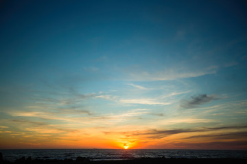Fototapeta na wymiar Fantastic sunset in the blue sky over the ocean.