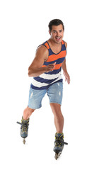 Handsome young man with inline roller skates on white background