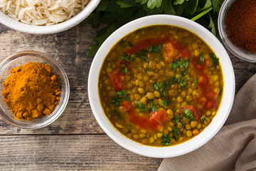 Indian lentil soup dal (dhal) in a bowl on wooden table. Top view