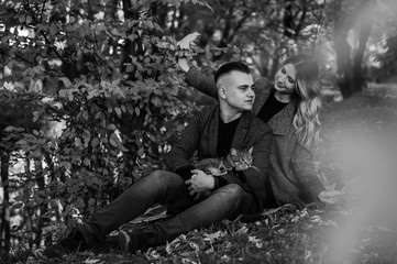 love, relationship, family and people concept - smiling couple having fun in autumn park