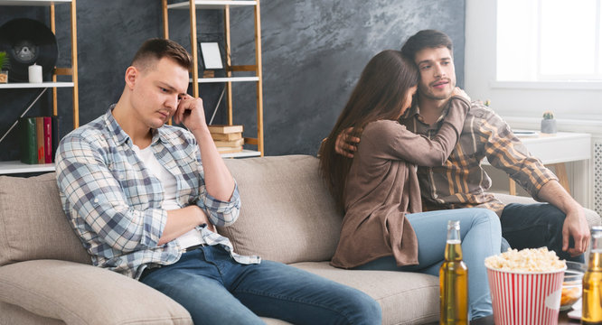 Love triangle. Sad man jealous to couple in love.