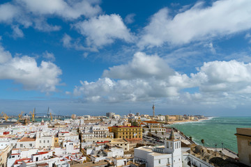 Nice panoramic view of the whole city from the cathedral bell tower - city rooftops, part of harbour and azure waters of the Ocean. Cadiz, Andalusia, Spain, Europa.