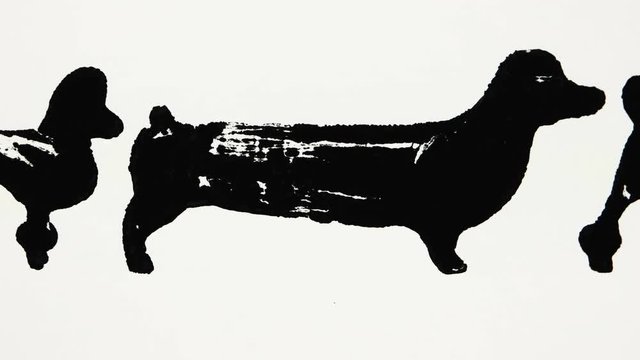 Black silhouettes of dachshund and poodle on the white background, graphic arts