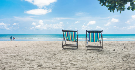 Two beach chairs on the tropical sand beach