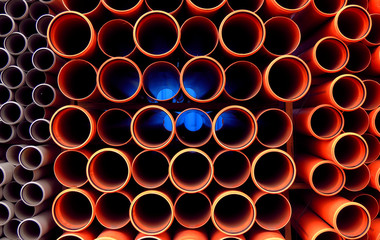 Plastic orange pipes stacked detailed photo
