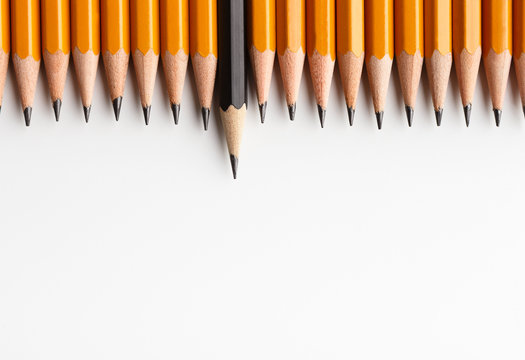 Row Of Classic Yellow Pencils With One Black Protruding