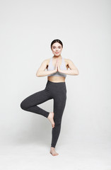 Obraz premium Portrait of attractive woman doing yoga, pilates. Healthy lifestyle and sports concept.