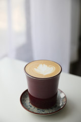 cappuccino or Latte art coffee made from milk on the wood table in coffee shop