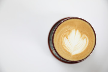 cappuccino or Latte art coffee made from milk on the wood table in coffee shop