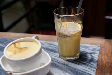 Vietnamese egg coffee hot and cool in the white coffee mug, cup in HANOI VIETNAM