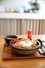 Japanese food Gyudon Japanese beef on rice bowl topped with egg on wooden table