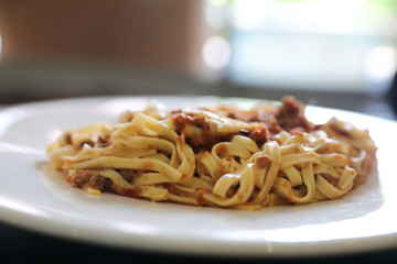 spaghetti Bolognese with minced beef and tomato sauce garnished with parmesan cheese and basil , Italian food