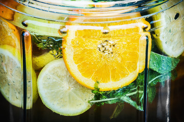 drink lemonade homemade of lemons, lime, oranges and mint with ice in a decanter