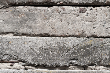 Old concrete blocks wall background closeup