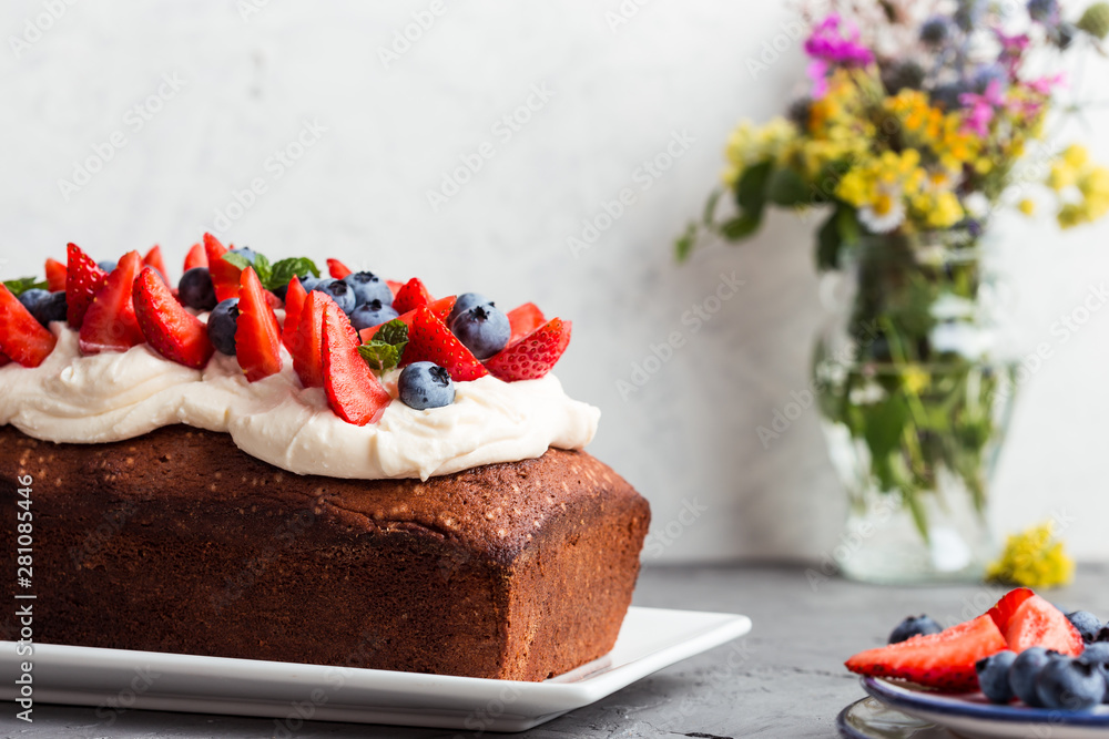 Wall mural Cake with buttercream and fresh colorful fruits and berries on top