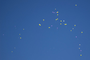 Balloons in the sky. Festive balloons fly through the air. Many balloons filled with helium and released up. Festive background.
