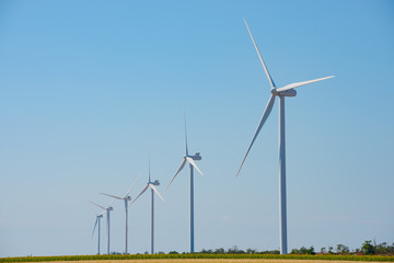 Wind Generator Turbines on the Blue Sky Bacground. Green Renewable Energy Concept.