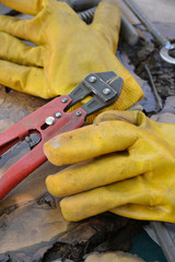 worker gloves with pliers on background