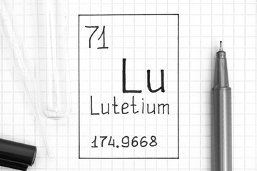 The Periodic table of elements. Handwriting chemical element Lutetium Lu with black pen, test tube and pipette.