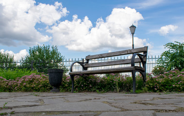 Obraz premium Vintage bench on the background of clouds and beautiful nature.