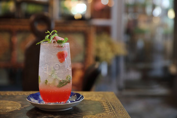 Strawberry mojito cocktail drink on wood background