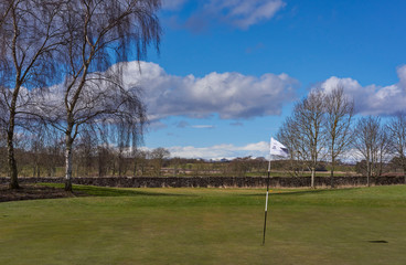 The Green and Pin Marker at Hole 1 of the Glens Course at Letham Grange Golf Club in Colliston, Arbroath, Scotland.
