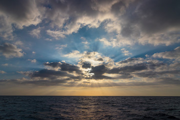 Impressive sunbeams in a cloud. The picture is taken from the sea in Tenerife Spain.