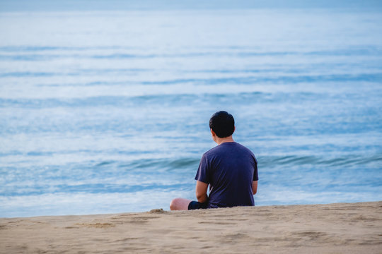 A man sitting on the beach