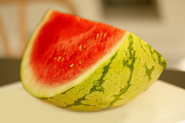 Fresh juicy watermelon slice on a table. - Image