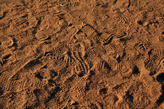 Many footprints in the sand.