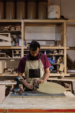 Craftsman working on skateboard
